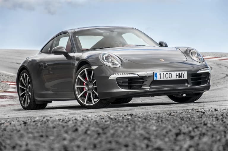 Gray Porsche 911 Carrera 4S from the 991 generation on a road.