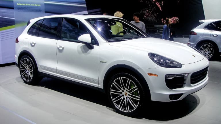 White Porsche Cayenne S E-Hybrid from the 958 generation displayed indoors.