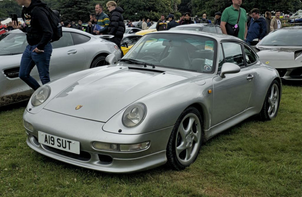 Silver Porsche 993 parked in grass