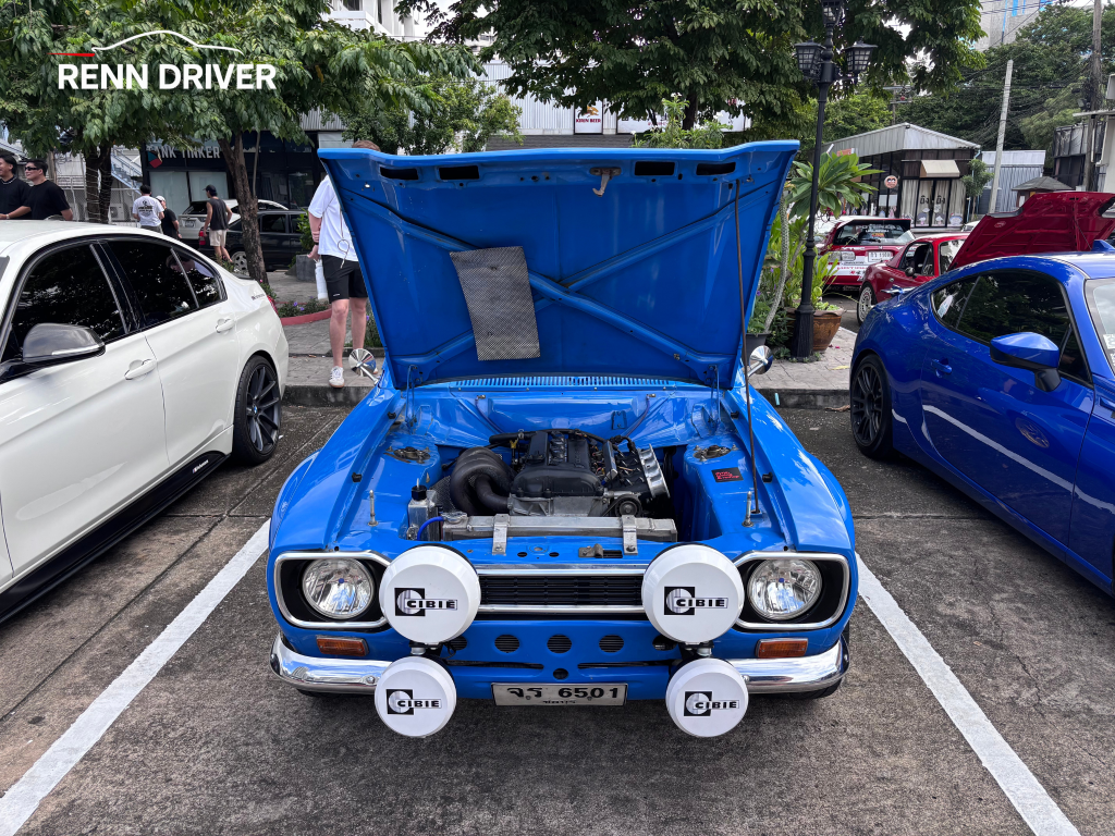 Blue Escort Mk1 with hood up and four Cibie lamps, front view.