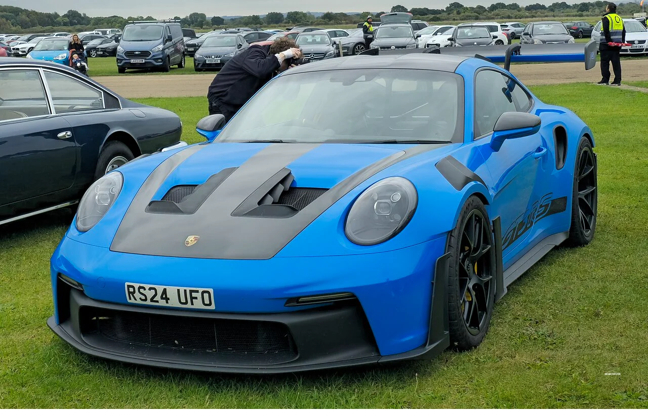 Blue Porsche 992 GT3 RS with rear wing and carbon fiber hood