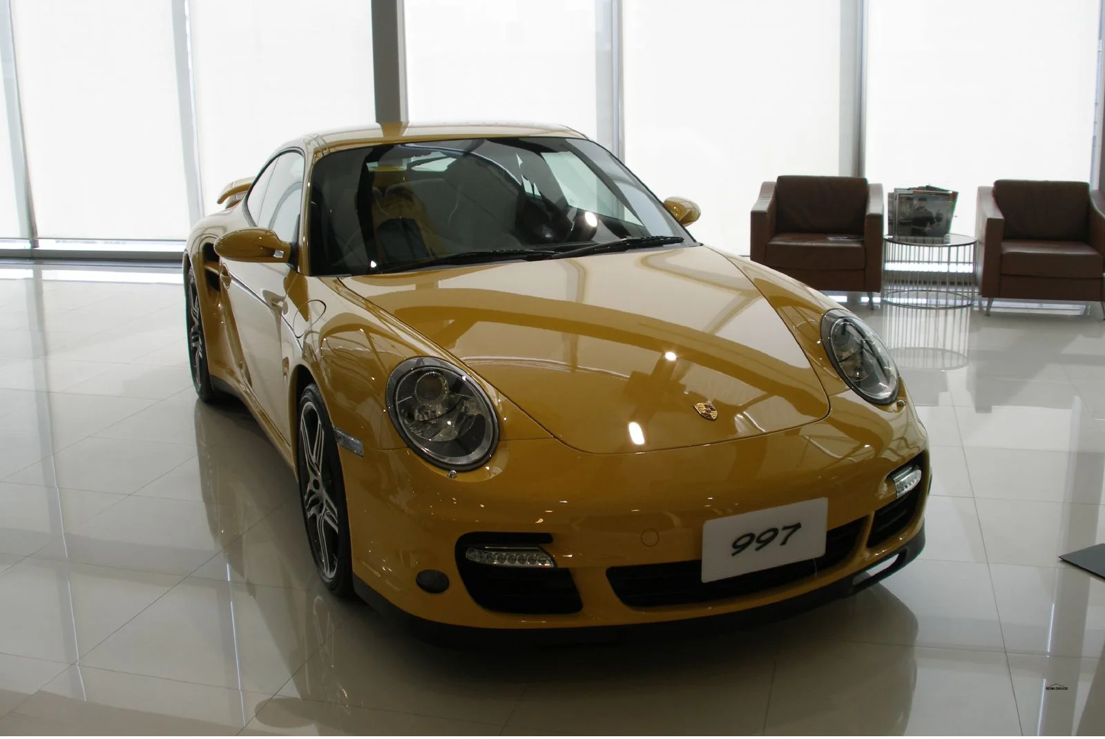 Yellow Porsche 997 Turbo in a Bangkok showroom