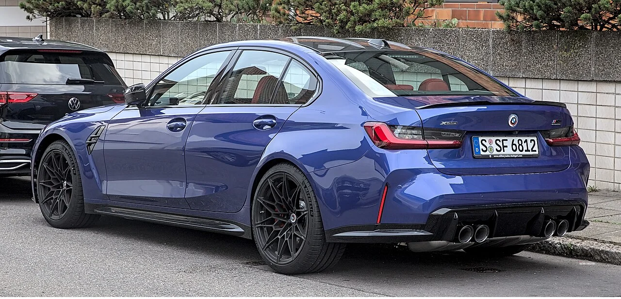 Blue BMW M3 Competition G80 rear three-quarter view