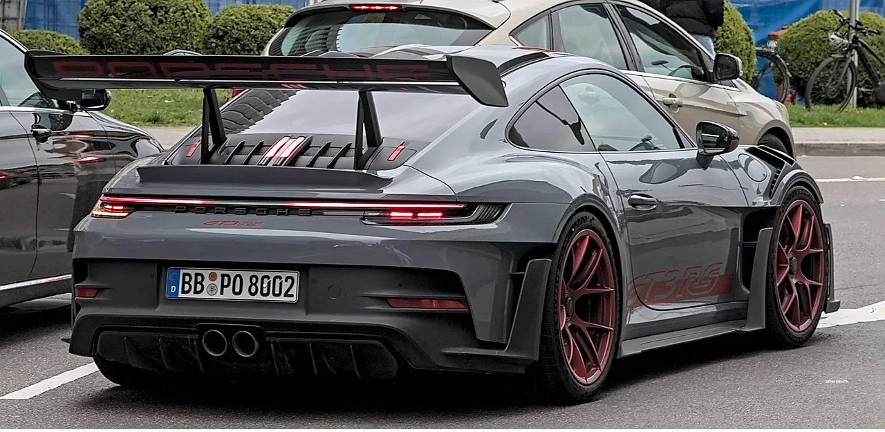 Grey Porsche 992 GT3 RS rear three quarter view with large rear wing