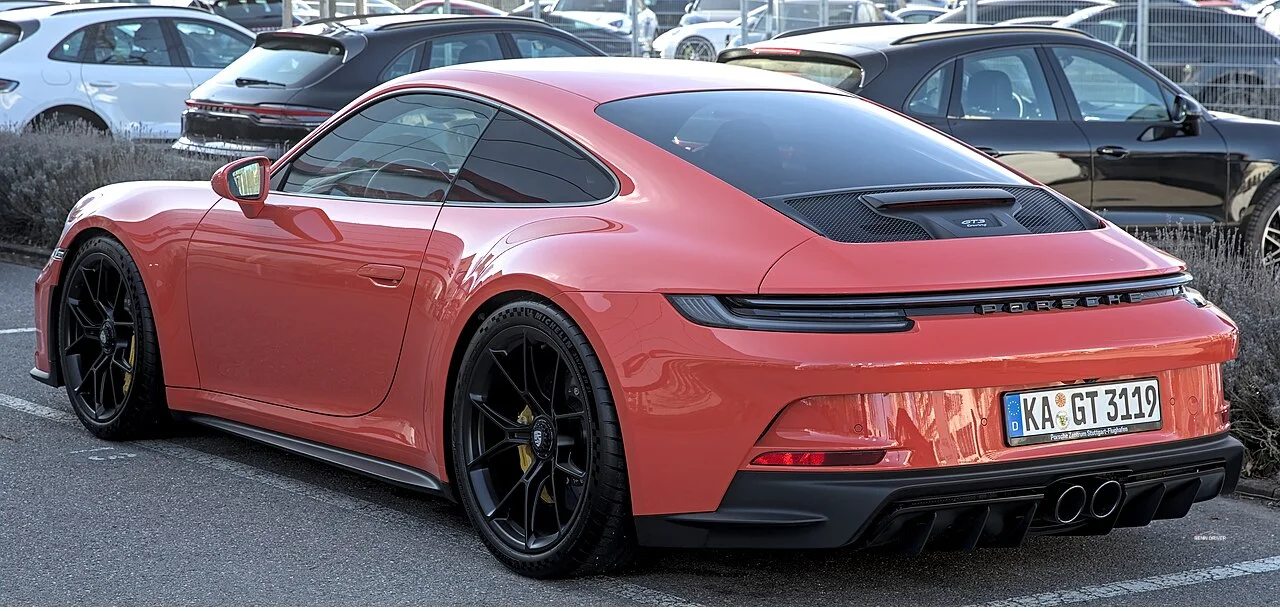 Red Porsche 992 GT3 Touring rear three quarter view