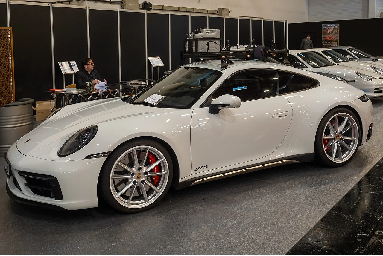 White Porsche 911 on display at a motor show