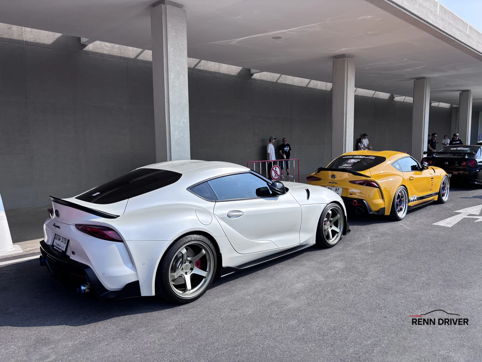 White widebody Toyota Supra and yellow Supra