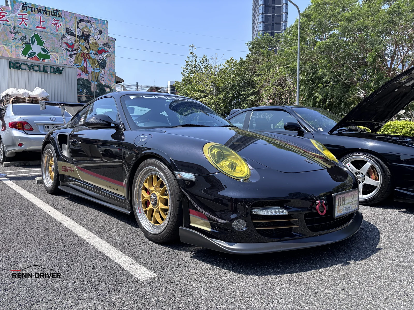 Black Porsche 997 Turbo with gold wheels