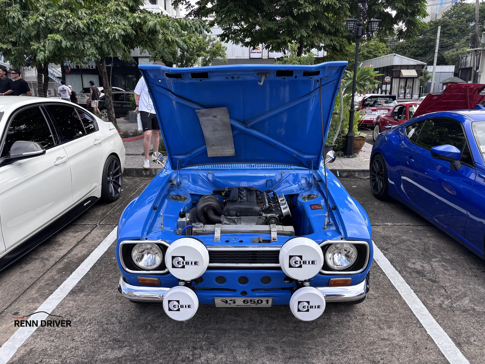 Blue Datsun 1200 with hood open