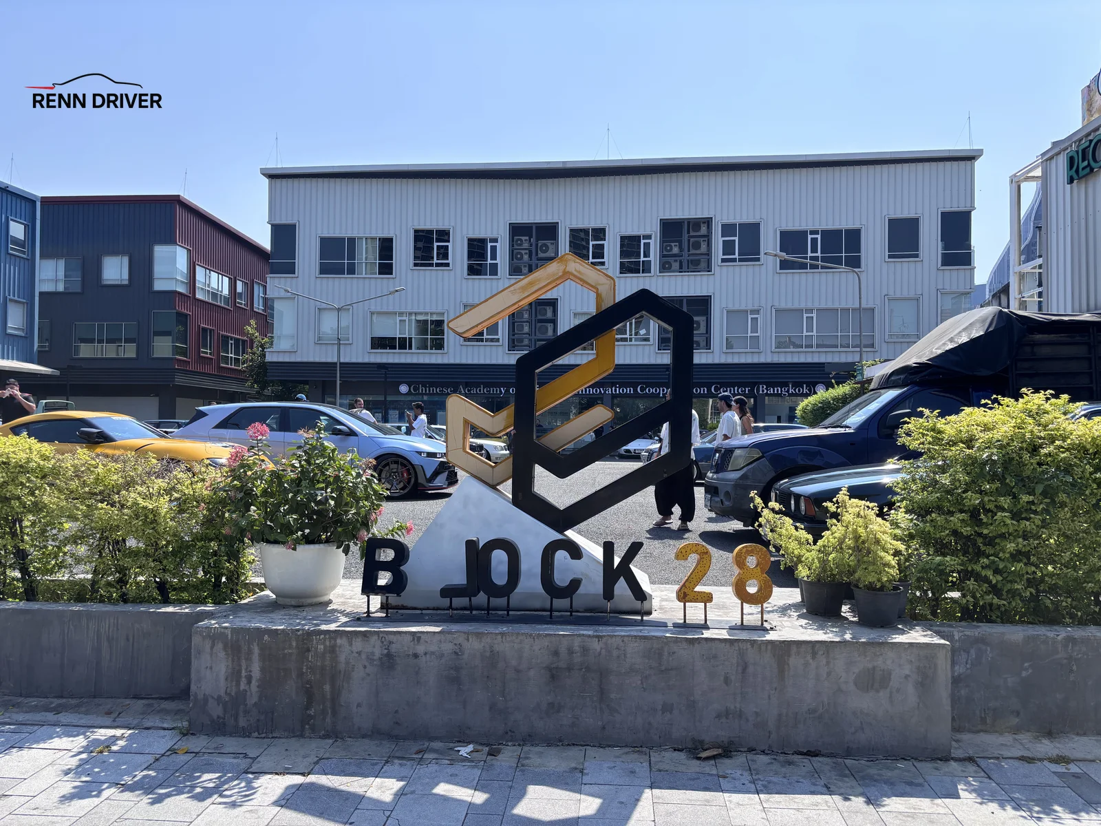 Block 28 entrance sign with cars parked behind