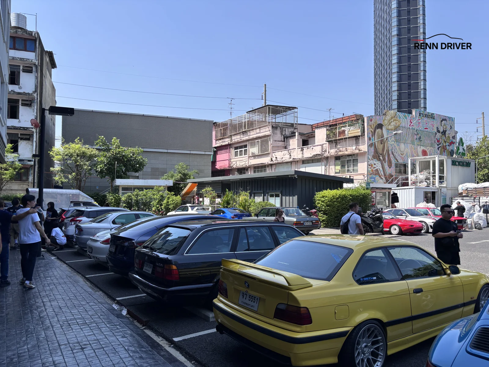 Parking area with cars lined up and shipping containers