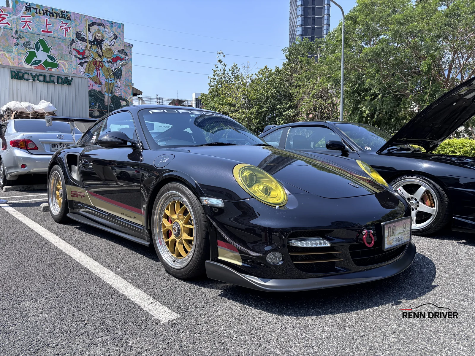 Black Porsche 997 GT2 with gold wheels front angle
