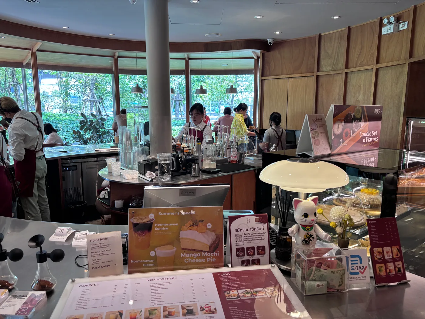Round coffee bar and counter inside Horme Cafe with large windows