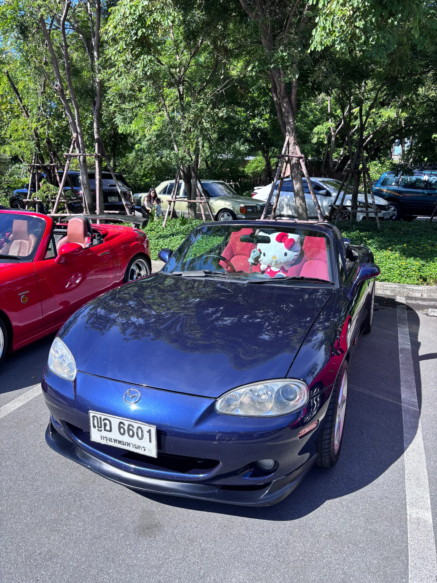 Blue Mazda MX-5 with red interior at a car meet