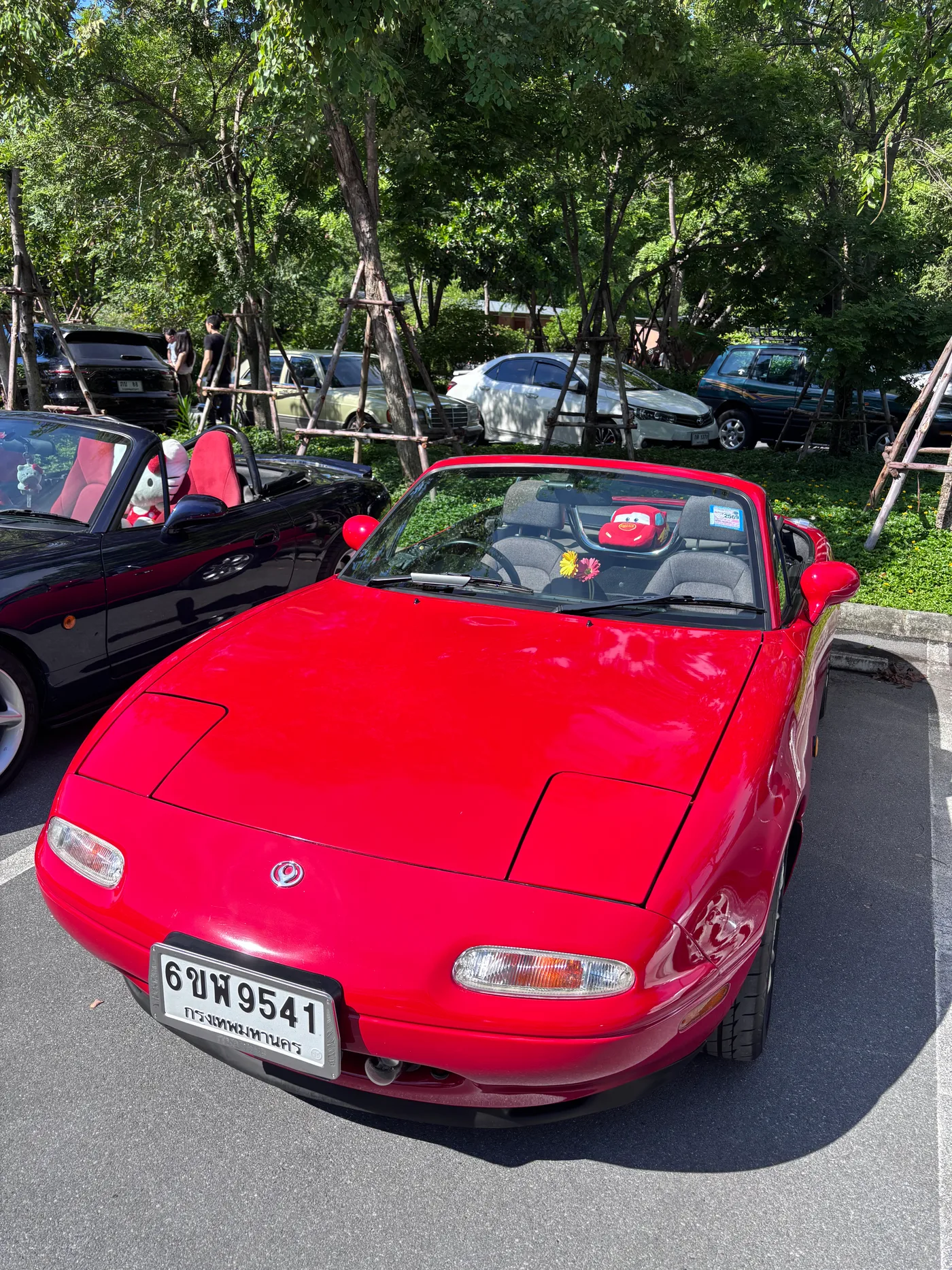 Red Mazda MX-5 roadster at a car meet
