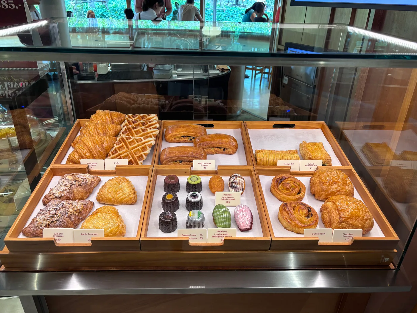 Pastry display case with croissants, danishes and waffles