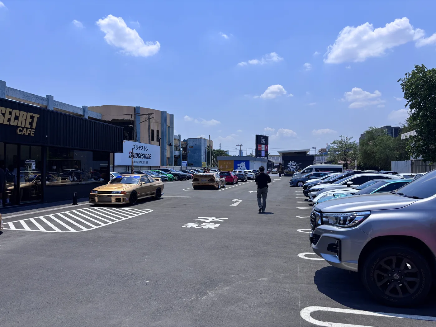 Parking lot beside Top Secret Cafe filling with cars
