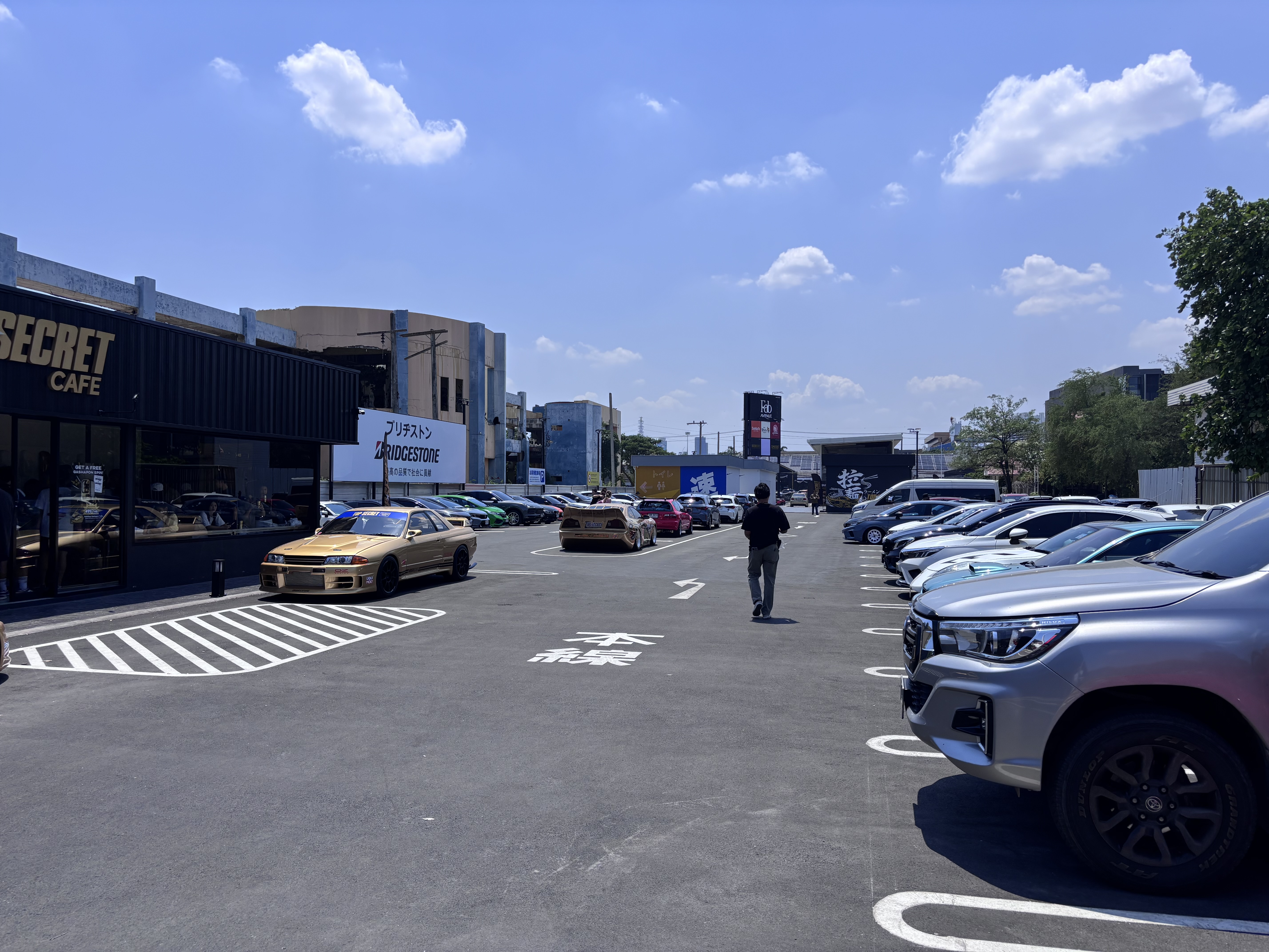 Top Secret Cafe parking lot with modified cars and Bridgestone signage
