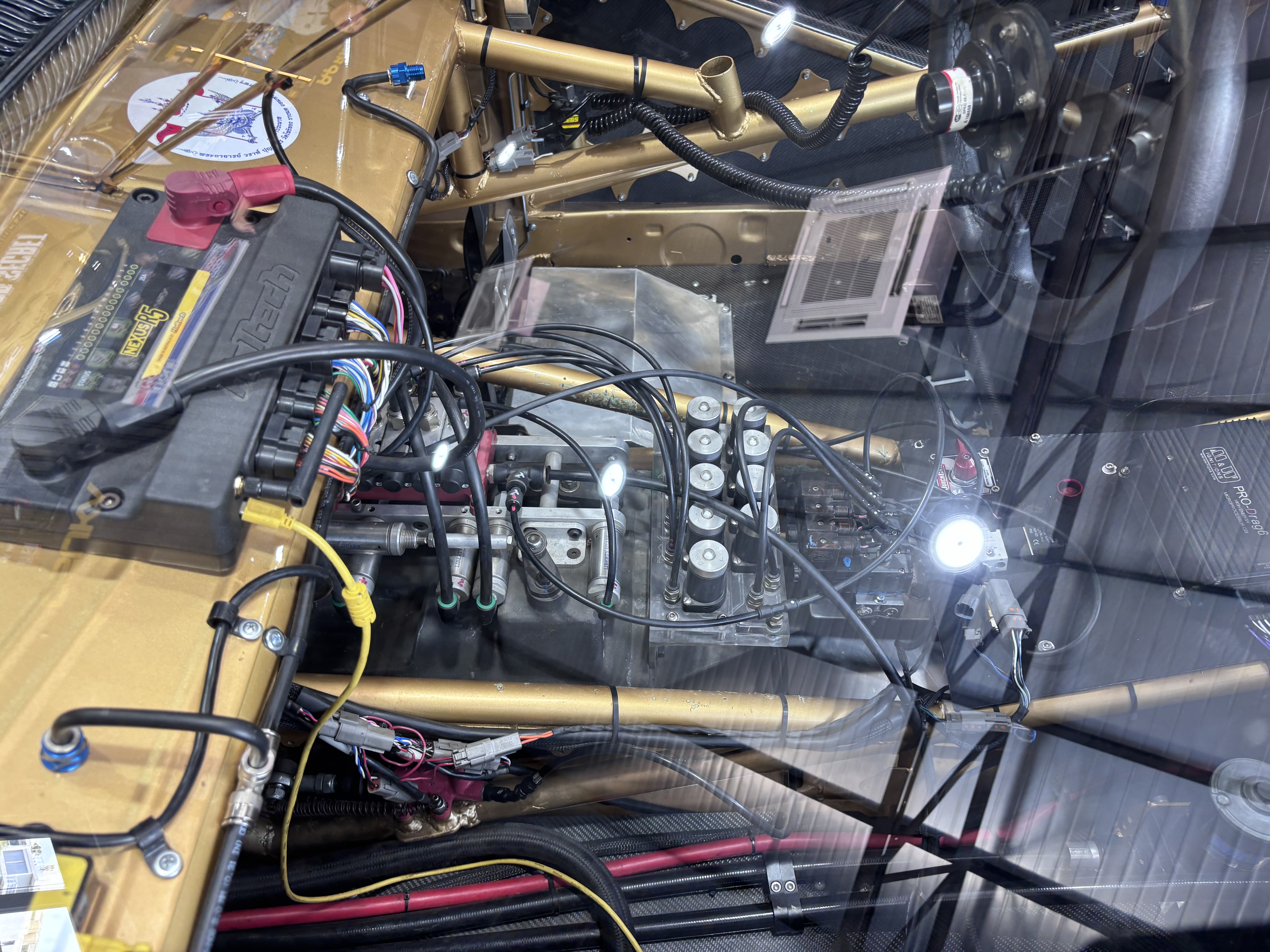 Engine bay detail of a gold Top Secret race car