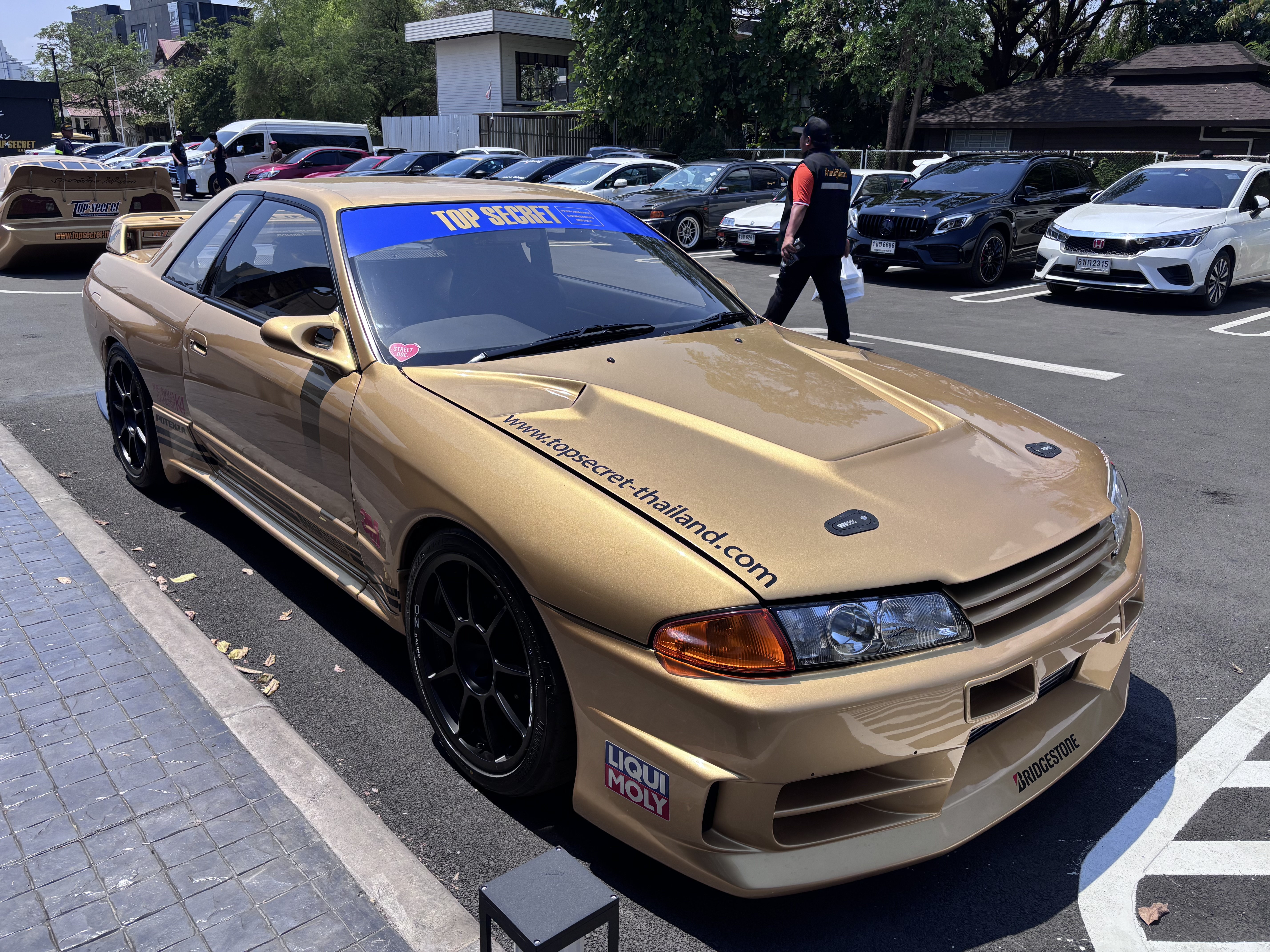 Gold R32 Skyline GT-R in the Top Secret Cafe parking lot